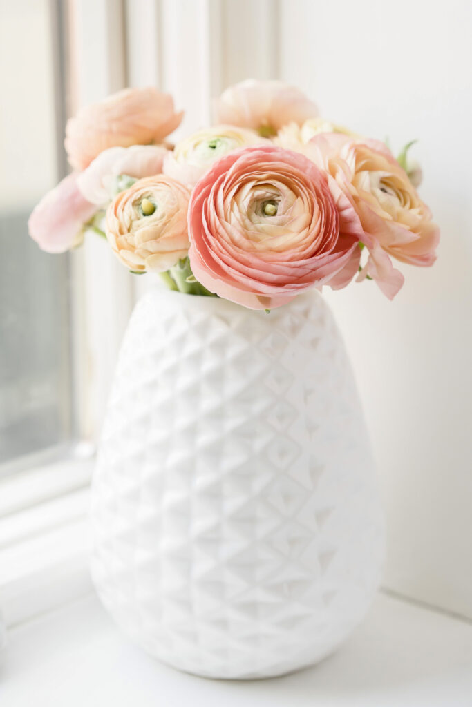 orange flowers in a white vase