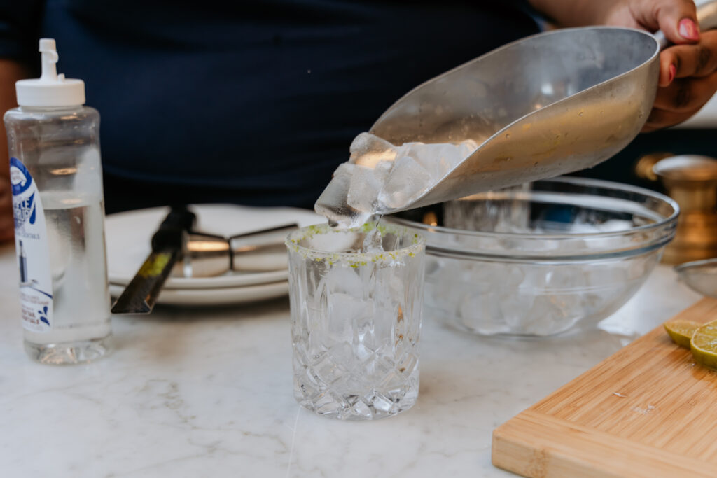 Filling a glass with ice.