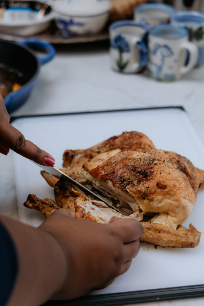 Kandice is carving herb roasted chicken.