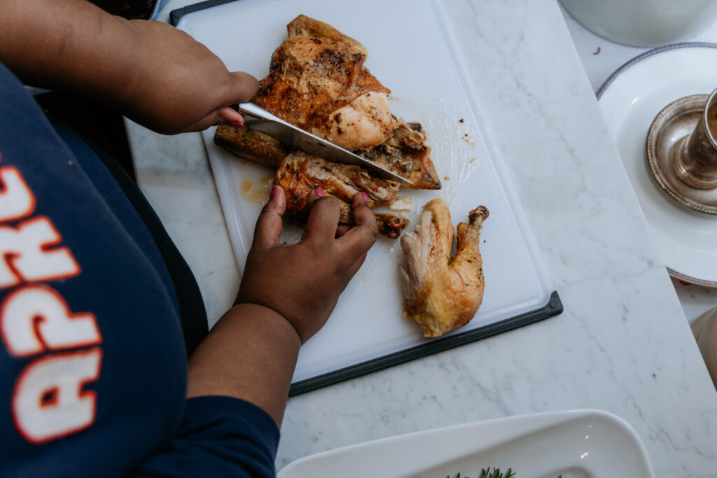 Overhead shot of chicken being cut into pieces.