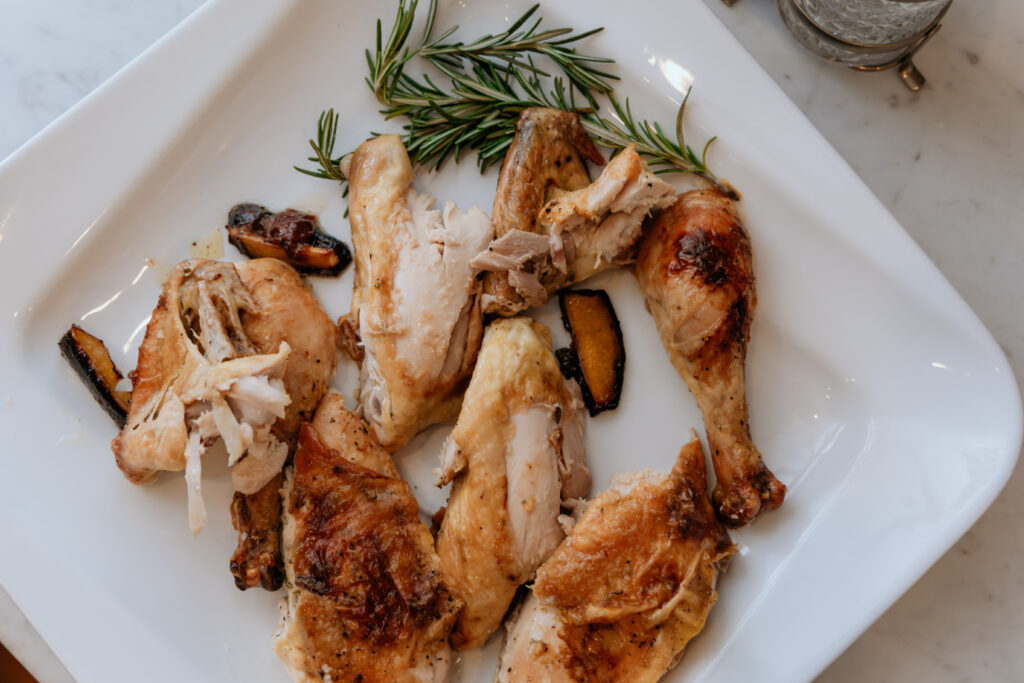 Pieces of roasted chicken on a serving platter.