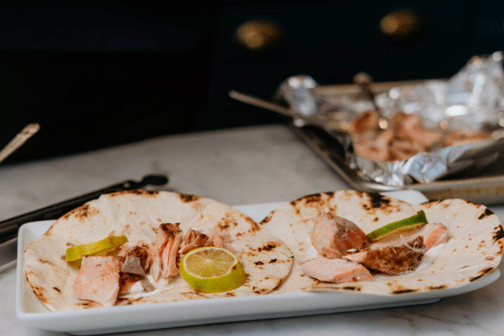 Topping salmon with lime  slices.