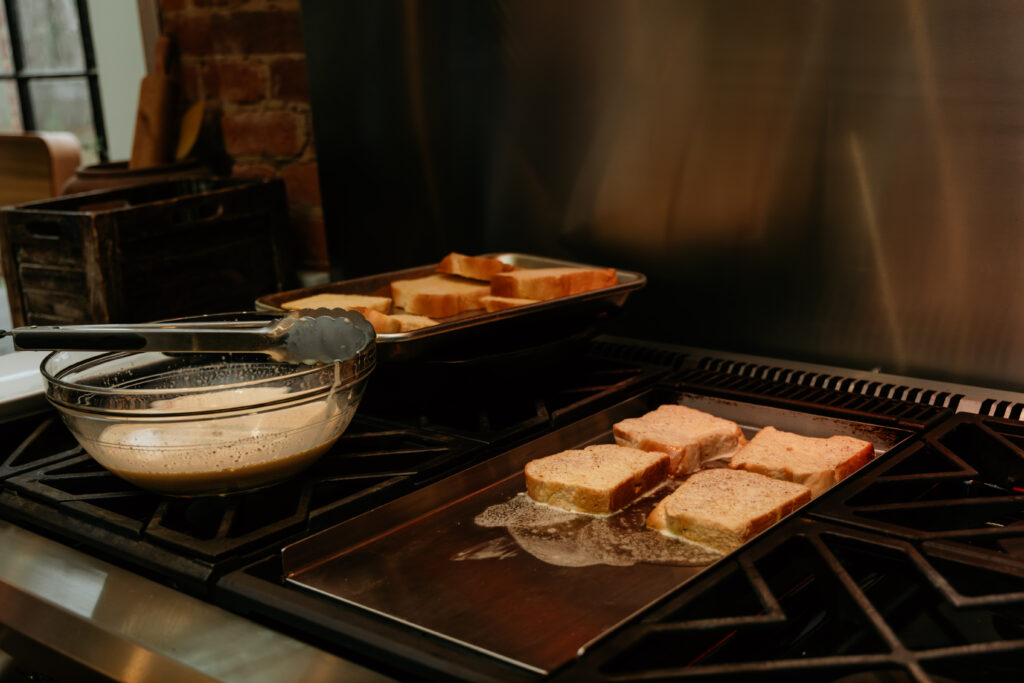 Adding french toast to a hit griddle. 