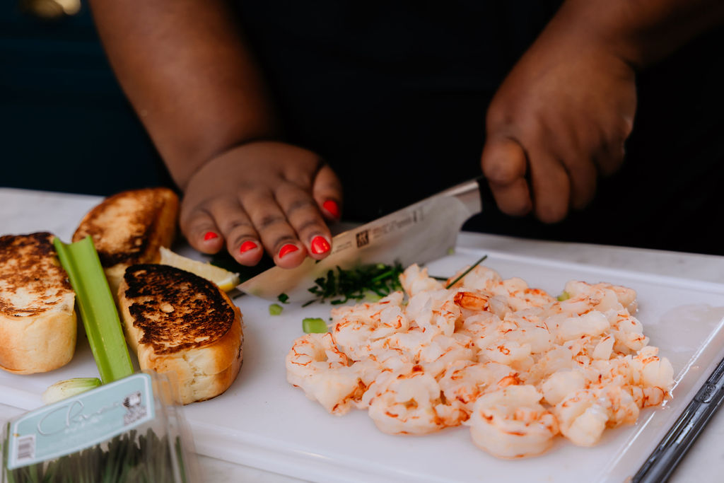 Close-up of Kandice chopping chives.