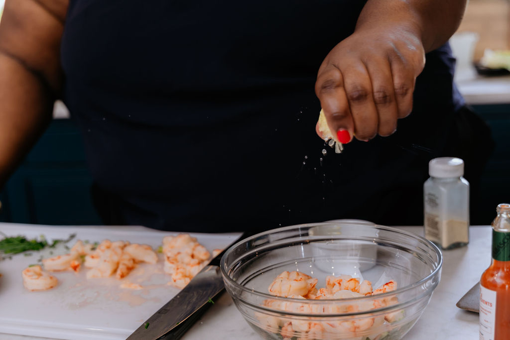 Lemon juice is being squeezed into a bowl.