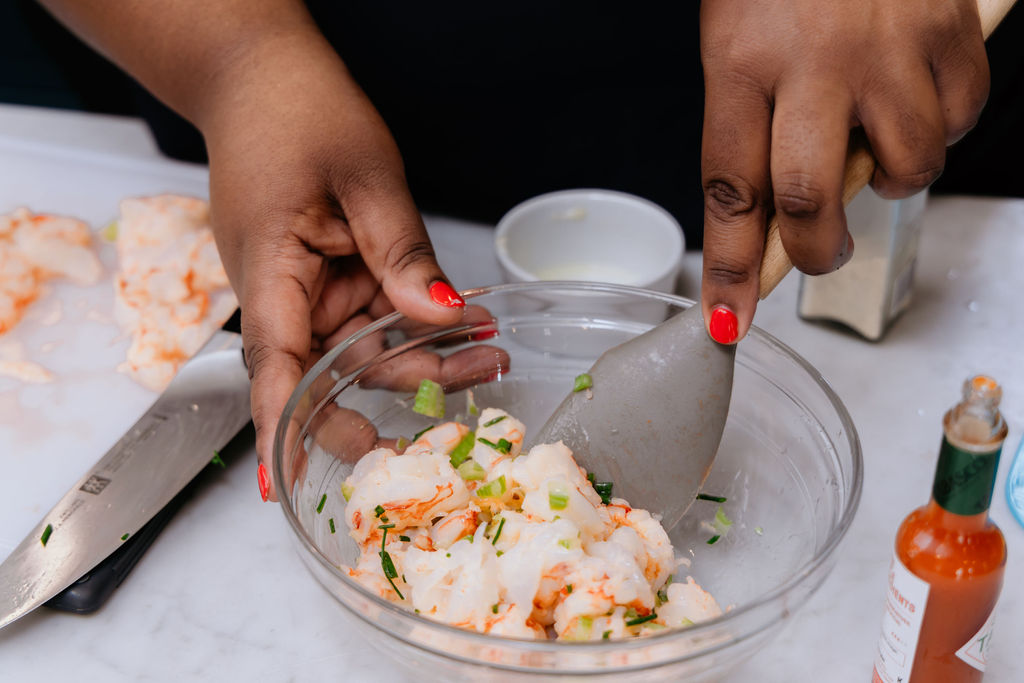 Kandice is mixing ingredients in a bowl.