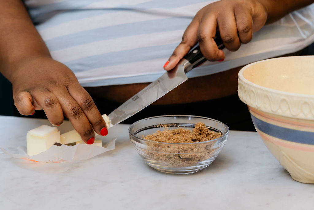 Kandice is slicing butter into small cubes.