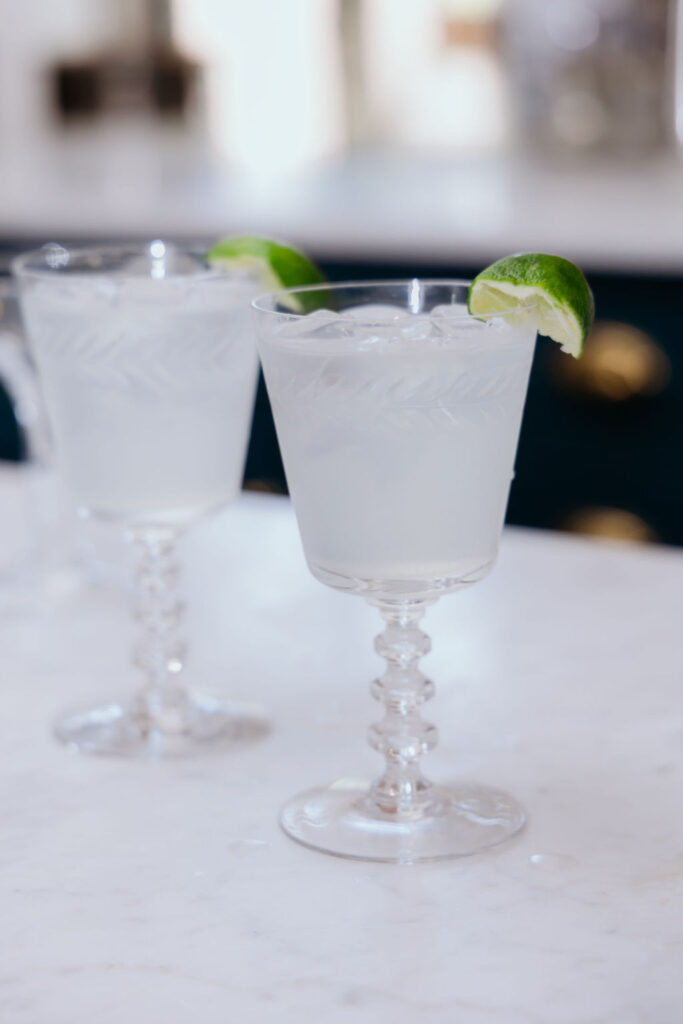 Two glasses of texas ranch water sit on a countertop.