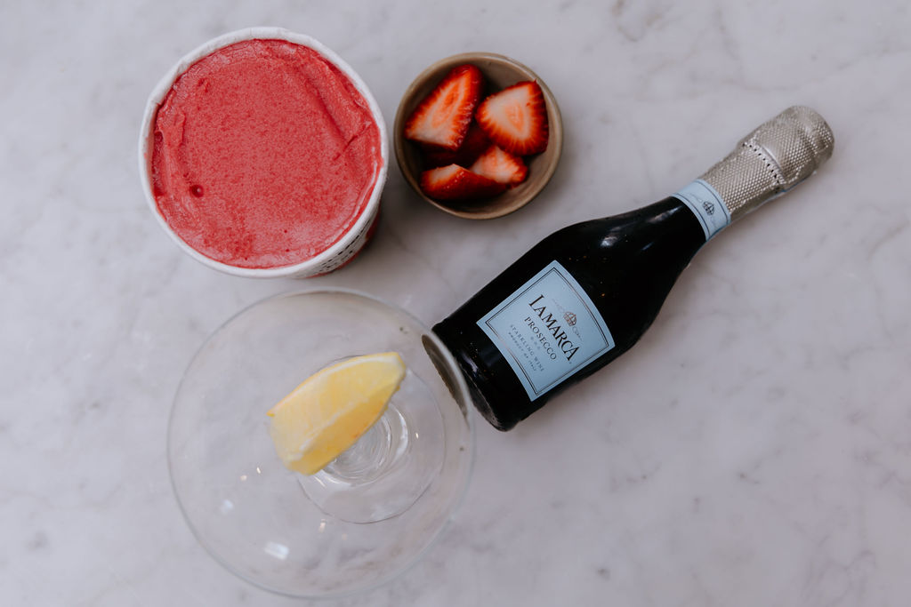 A flat lay of raspberry sorbet Prosecco float