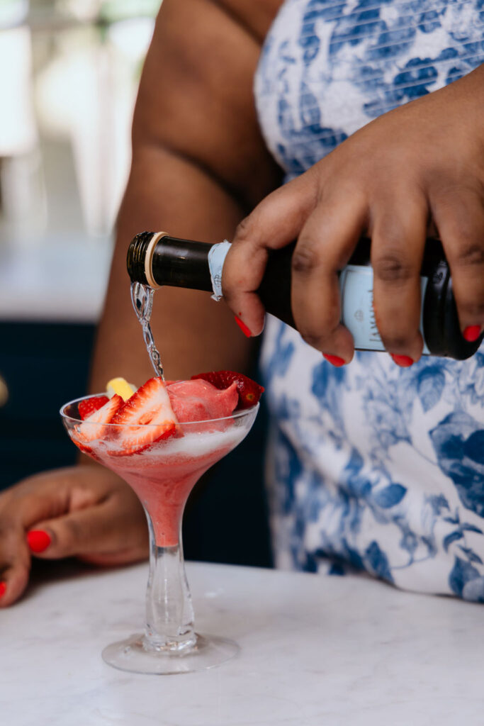 Kandice is pouring Prosecco over sorbet,