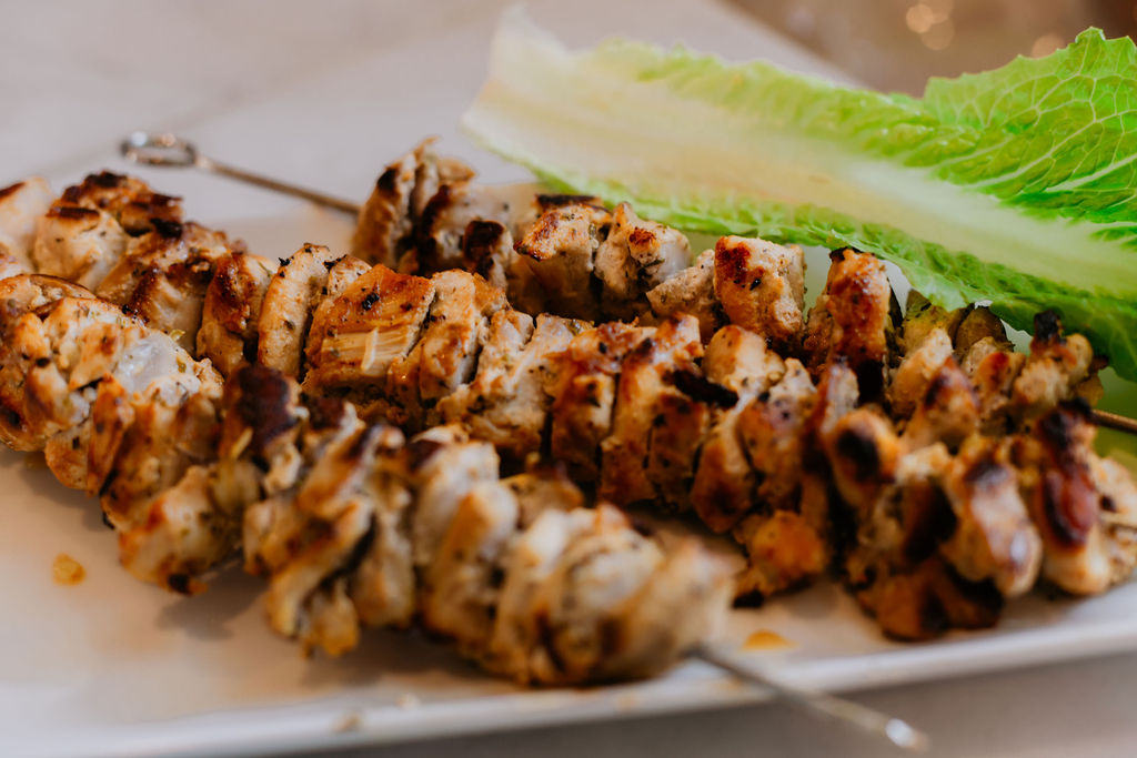 Close up of  chicken gyro skewers with lemon yogurt sauce