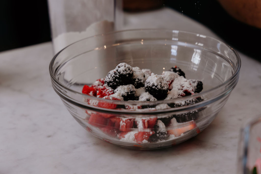 Berries in a bowl sprinkled with flour.