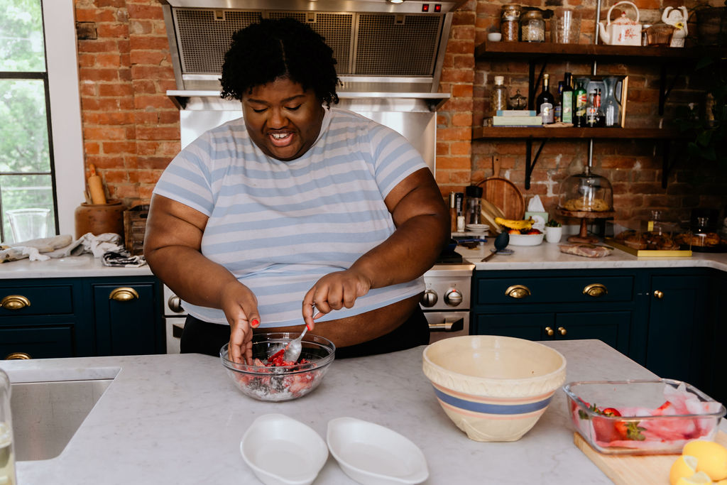 Kandice is mixing berries with flour, sugar, and lemon juice.