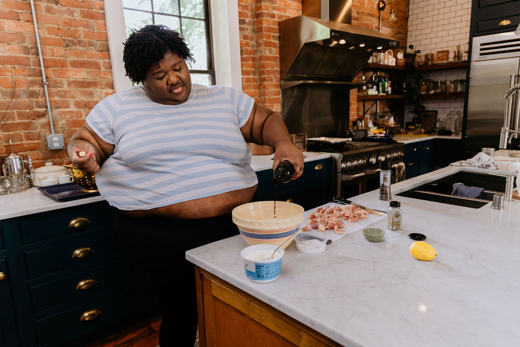 Kandice is adding red wine to marinade.