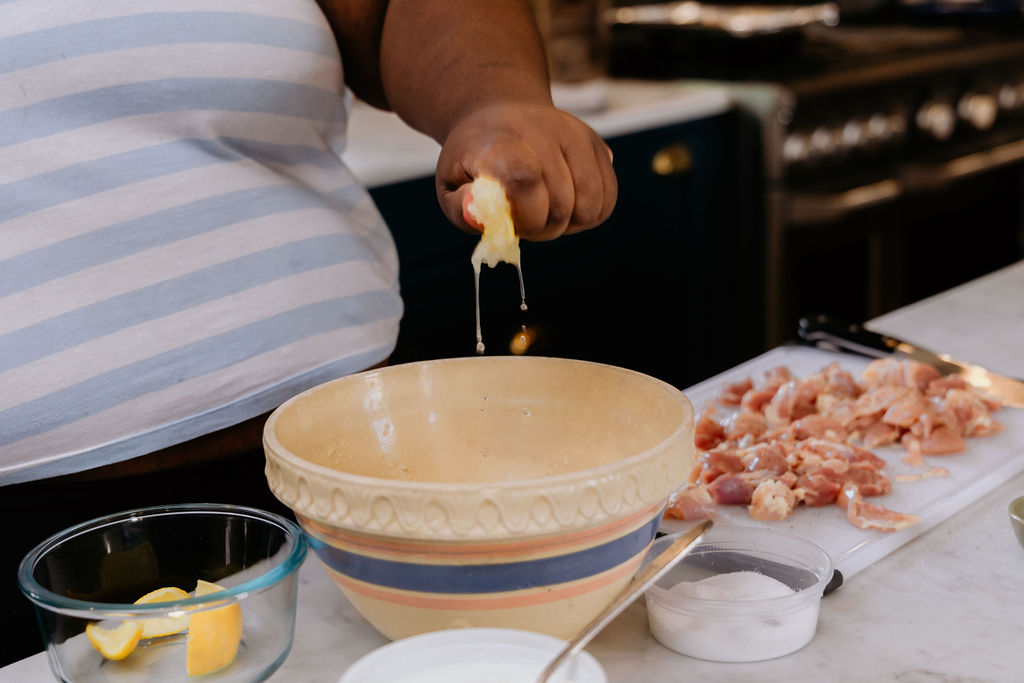 Kandice is adding lemon juice to marinade.