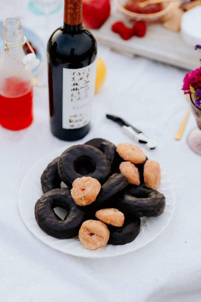 A platter of donuts and wine.