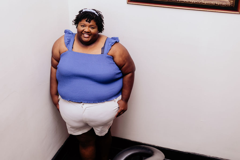 Kandice is showing how to style white shorts with a baby blue smocked top.