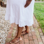 Closeup of the bottom of the dress and the sandals.