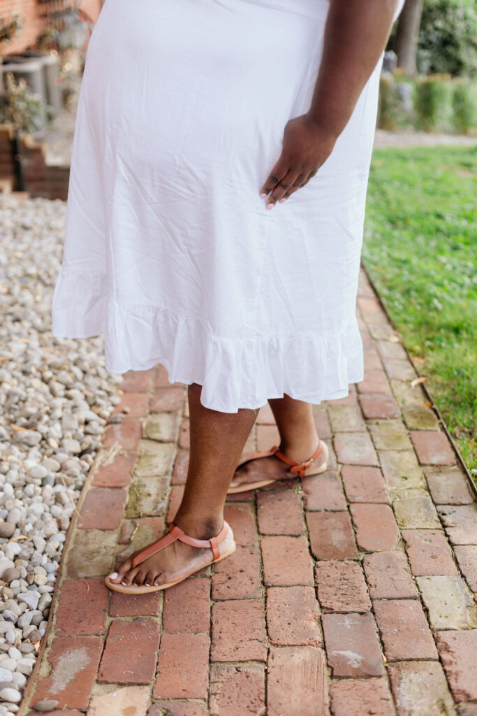 Closeup of the bottom of the dress and the sandals.