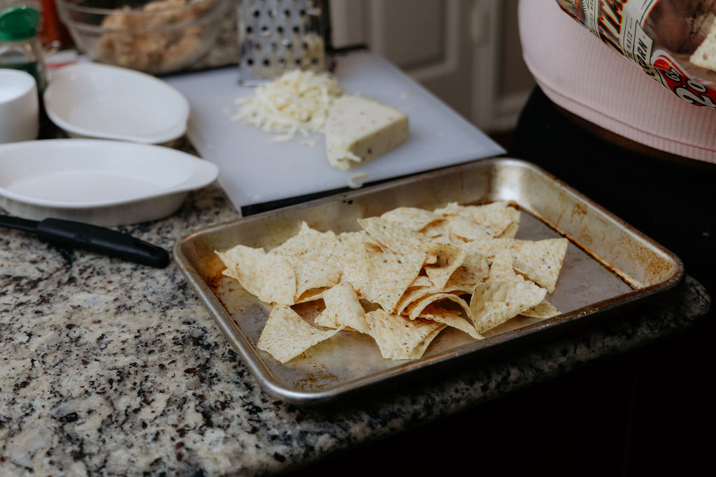 Layer of tortilla chips on a sheet pan.